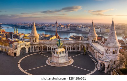 Budapest, Hungary - The famous Fisherman's Bastion at sunrise with statue of King Stephen I and Parliament of Hungary at background - Shutterstock ID 1284286561