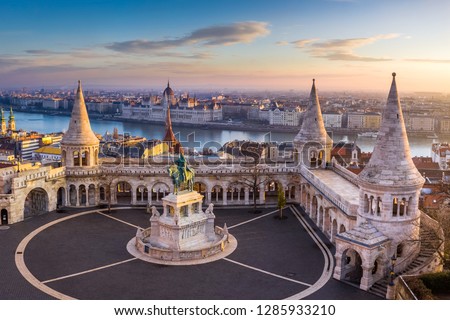 Budapest, Hungary - The famous Fisherman's Bastion at sunrise with statue of King Stephen I and Parliament of Hungary at background