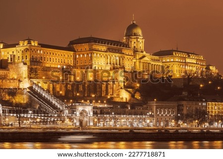 Budapest, Hungary Illuminated night view of Buda Castle Palatial venue, seen from the banks of river Danube.
