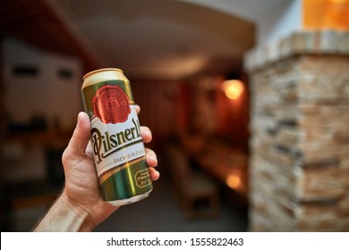 BUDAPEST, HUNGARY - JANUARY 29, 2018: Holding a can of Pilsner Urquell, popular Czech beer brewed in Plzen