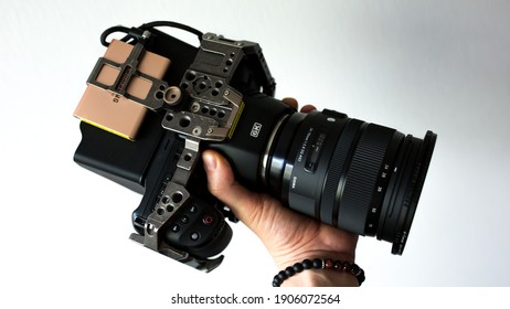 Budapest, Hungary - January 31, 2020: Man Holding His Black Magic Camera, With Sigma ART 24-70 Lens. 