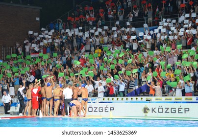 Budapest, Hungary - Jul 14, 2014. Fans of the hungarian waterpolo team hold red-white-green papers. The Waterpolo European Championship was held in Alfred Hajos Swimming Centre in 2014.