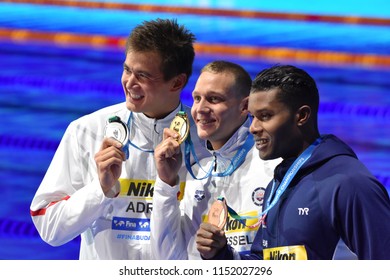 Budapest, Hungary - Jul 27, 2017. METELLA Mehdy (FRA), ADRIAN Nathan (USA) and the winner DRESSEL Caeleb Remel (USA) at the Victory Ceremony of the Men 100m Freestyle. FINA Swimming World Championship