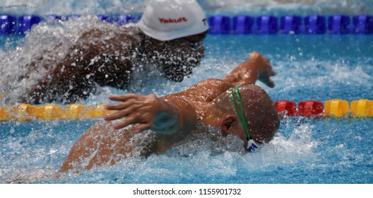 Budapest, Hungary - Jul 28, 2017. Competitive swimmer CSEH Laszlo (HUN) and METELLA Mehdy (FRA) swimming 100m butterfly. FINA Swimming World Championship Preliminary Heats in Duna Arena.
