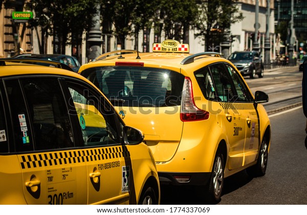 Budapest Hungary\
july 11, 2020 View of a traditional yellow Hungarian taxi for\
passengers driving through the streets of Budapest the capital and\
the most populous city of\
Hungary
