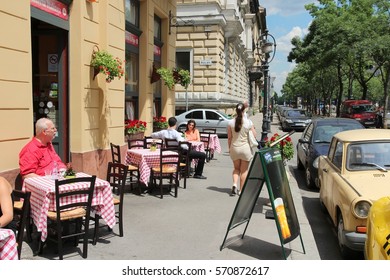 BUDAPEST, HUNGARY - JUNE 19, 2014: People sit at restaurant by Andrassy Avenue in Budapest. 3.3 million people live in Budapest Metropolitan Area.