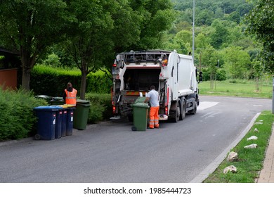 Budapest, Hungary - June 2, 2021: Trash Workers Collect Garbage With Garbage Truck In Budapest Suburb Green Area, Hungary