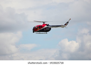 BUDAPEST, HUNGARY - JUNE 24, 2018:A Red Bull aerobatic helicopter demonstrates different flying techniques during an open for the public air show at the city of Budapest.
