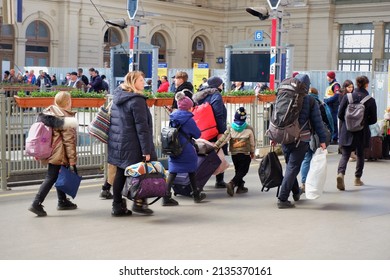 Budapest, Hungary - March 14, 2022: Ukrainian Refugee Family Hurry To The Train With Luggage At The East Railway Station