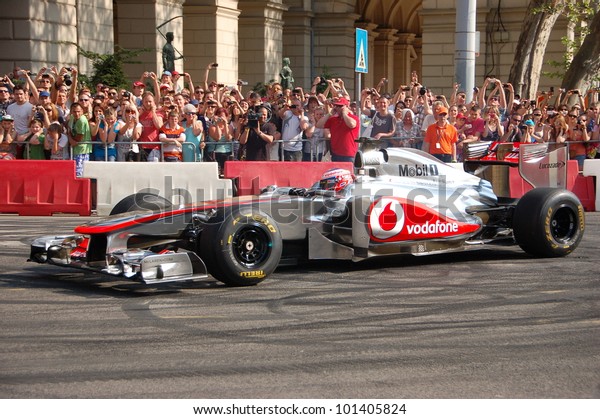 BUDAPEST,\
HUNGARY-  MAY 1: F1 driver Jenson Button does some burnouts for his\
fans on May 1, 2012 on streets in\
Budapest.