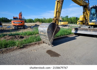 Budapest, Hungary - May 19, 2022: excavator and construction equipment in a residential park construction area in Budapest suburb
