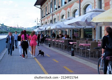 Budapest, Hungary - May 27, 2021: People Walking And Cycling On The Downtown Danube Bank