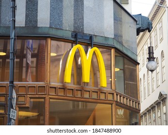 Budapest, Hungary - November 3, 2020: Yellow Curved Mc Donald's Logo Sign On The Facade Of A Mac Donald Restaurant In Budapest Downtown