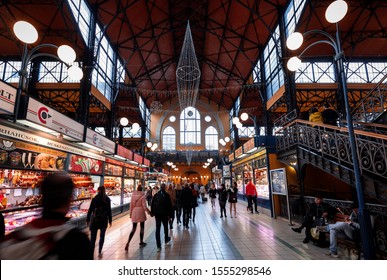 BUDAPEST, HUNGARY - NOVEMBER 9.  2019: People Walking And Shopping In The Monumental Central Market Hall In Budapest