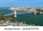 Budapest, Hungary. Szechenyi Chain Bridge across the Danube in sunny autumn day. The Hungarian Parliament Building is visible in the background.