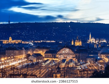Budapest at night lights with the Keleti railways station in the foreground and the Royal palace and the Matthias church in the background.