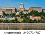 Budapest panoramic skyline view of the Budapest Castle, Buda Castle, on the Buda side of the Danube river with colorful homes on a sunny day with a beautiful blue sky. A Budapest, Hungary cityscape.