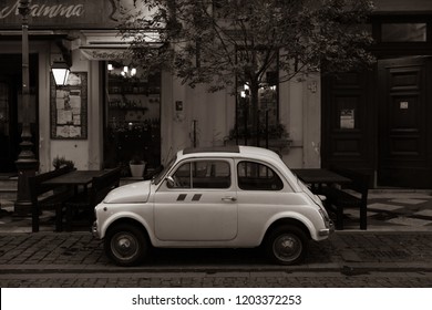 Budapest/Hungary - 10.03.2018, An Old Car In Front Of An Italian Restaurant. Vintage Effect Photo