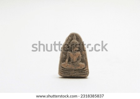 Buddha amulet made from mass powder, amulet, Thai amulet or votive tablet made of metal or clay isolated on white background.  Amulets are popular with Buddhists.