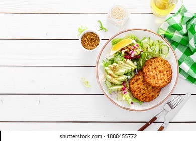 Buddha Bowl Dish With Grilled Chicken Burgers, Cucumbers, Avocado And Fresh Lettuce Salad For Lunch, Top View.