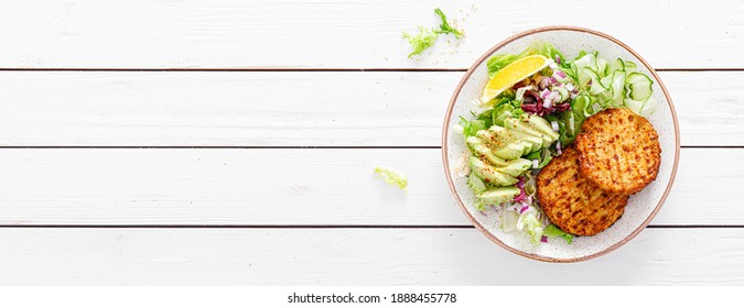 Buddha Bowl Dish With Grilled Chicken Burgers, Cucumbers, Avocado And Fresh Lettuce Salad For Lunch, Top View. Banner.