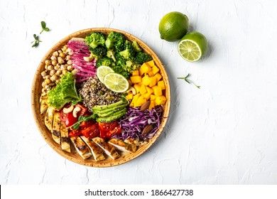 Buddha bowl, healthy and balanced food chicken fillet, quinoa, avocado, pumpkin, tomato, broccoli, red cabbage chickpea, watermelon radish, fresh lettuce salad nuts. Top view.