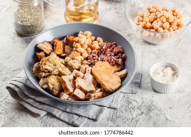 Buddha Bowl Lunch With Chicken And Red Rice, Chickpea, Cauliflower And Halloumi Cheese. Healthy Food Concept