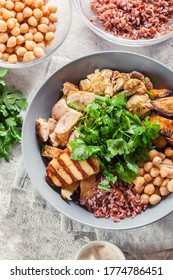 Buddha Bowl Lunch With Chicken And Red Rice, Chickpea, Cauliflower And Halloumi Cheese. Healthy Food Concept