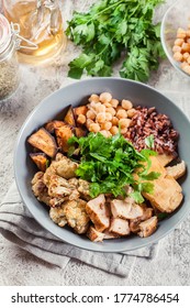 Buddha Bowl Lunch With Chicken And Red Rice, Chickpea, Cauliflower And Halloumi Cheese. Healthy Food Concept