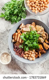 Buddha Bowl Lunch With Chicken And Red Rice, Chickpea, Cauliflower And Halloumi Cheese. Healthy Food Concept