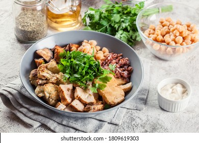 Buddha Bowl Lunch With Chicken And Red Rice, Chickpea, Cauliflower And Halloumi Cheese. Healthy Food Concept