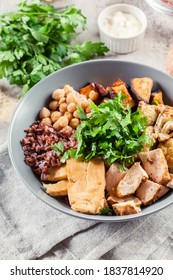 Buddha Bowl Lunch With Chicken And Red Rice, Chickpea, Cauliflower And Halloumi Cheese. Healthy Food Concept