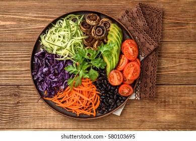 Buddha bowl of mixed vegetable on the wooden table.