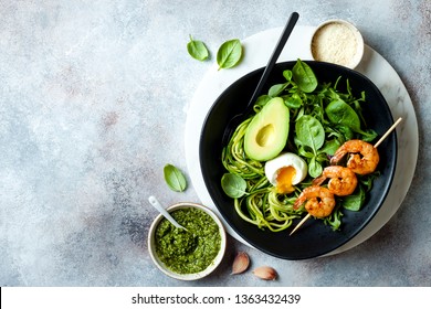 Buddha Bowl With Soft Boiled Egg, Avocado, Greens, Zucchini Noodles, Grilled Shrimps And Pesto Sauce. Vegetarian Vegetable Low Carb Lunch Bowl. 