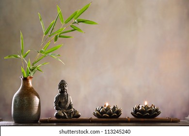 Buddha with candle and bamboo, religious concept.
