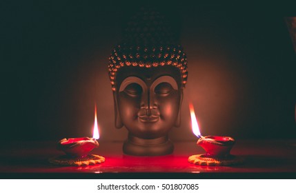 Buddha & Colorful Diya lamps lit during Diwali celebration