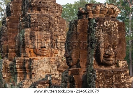 Buddha faces in traditional khmer architecture at sunset, Bayon temple, Angkor, Cambodia.