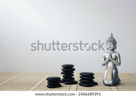 buddha figure with black stones