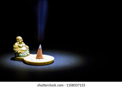 Buddha figurine with incense - Powered by Shutterstock