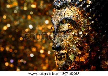 Buddha head filled with gold leaf. Shows the devotion of the Buddhists.