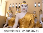 Buddha image in a temple in the courtyard of the Shwedagon Pagoda, a gilded stupa located in Yangon, Myanmar. It is the most sacred Buddhist pagoda in Myanmar.