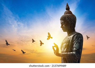 Buddha images belief in Buddhism, Big buddha statue on sunset sky
