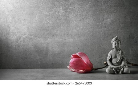 Buddha in meditation with magnolia flower