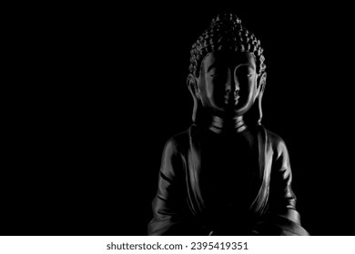 Buddha Purnima and Vesak day concept, Grey Buddha statue with low key light against deep black background close up. Meditation - Powered by Shutterstock