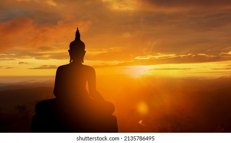 buddha silhouette on golden sunset background beliefs of Buddhism - Shutterstock ID 2135786495