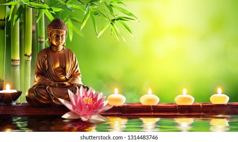 Buddha Statue With Candles In Natural Background