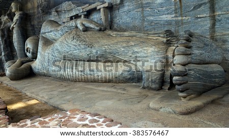 Buddha statue carved in to the rock The reclining image, which depicts the Buddha's parinirvana, is the largest in Gal Vihara, Sri Lanka, ancient city of Polonnaruwa, UNESCO World Heritage Site