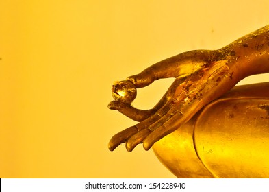 buddha statue hands on yellow background