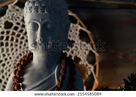 buddha statue image on altar with candles and plants