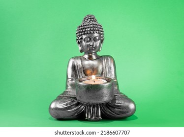 buddha statue with lit candle. green screen - Powered by Shutterstock